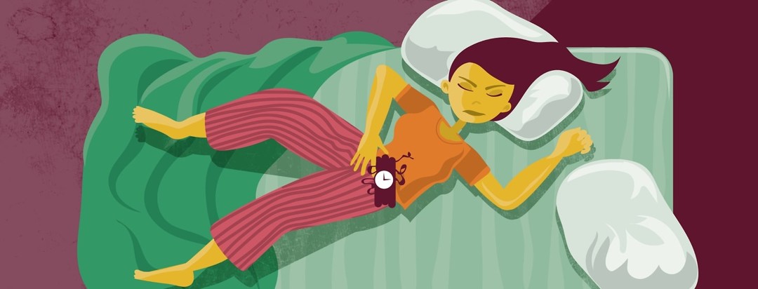 A woman lying on a bed with a time bomb on her stomach