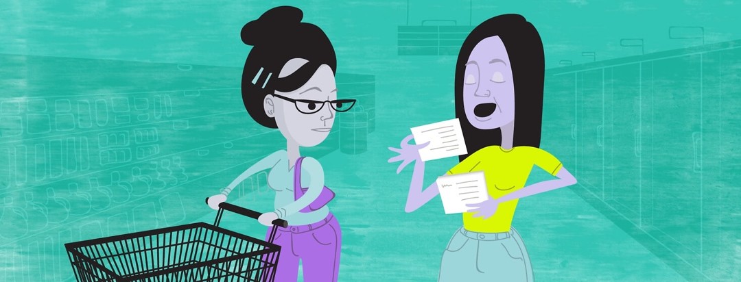 A woman reads from cue cards to another woman in a grocery store