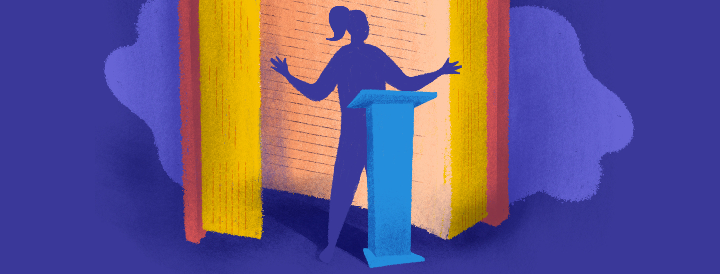 A woman stands in front of a large open book, behind a podium to tell her story.