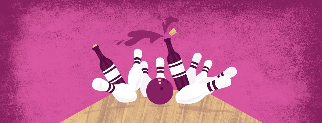 a bowling ball rolling down a lane, knocking over bowling pins, some of which are bottles of wine