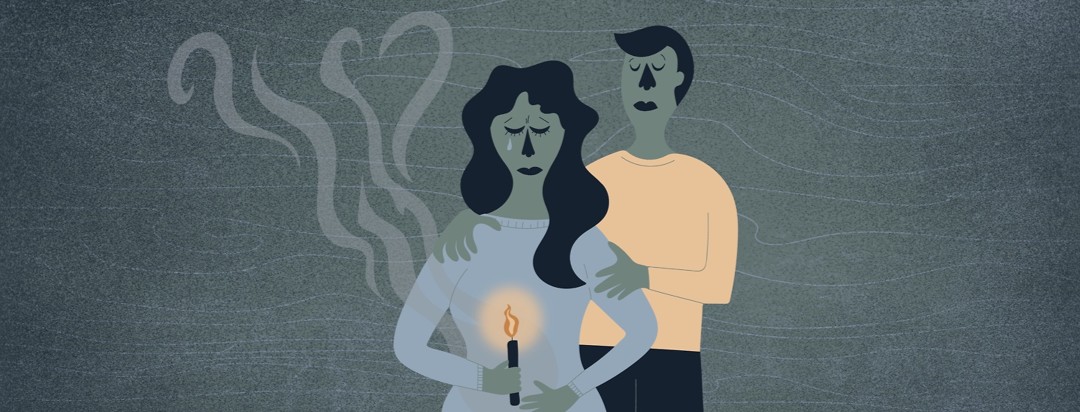 a man and a woman mourning their miscarriage by holding a candle and watching the smoke drift away creating a heart