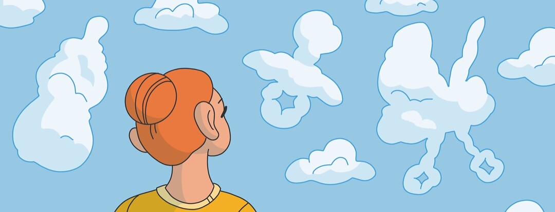 A woman looks up at a sky with clouds shaped like baby items