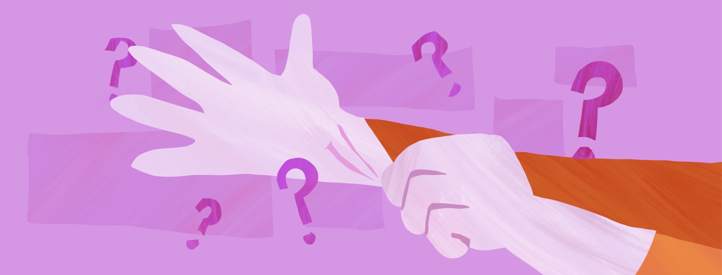 Hands pulling on a pair of surgical gloves