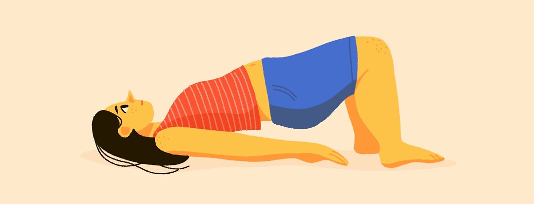 A woman lies on the floor and does a pelvic floor exercise