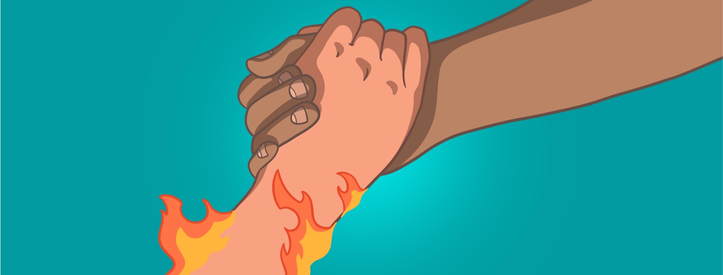 A hand grabs a hand that is on fire