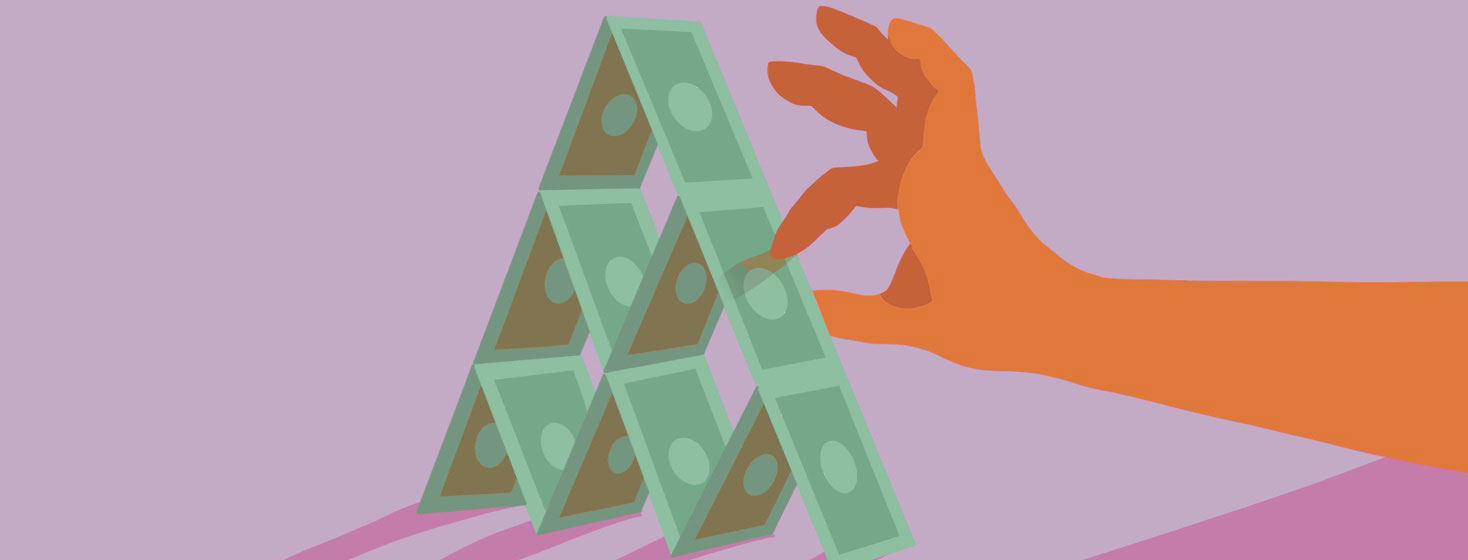 A hand balancing dollars into a pyramid shape like a house of cards